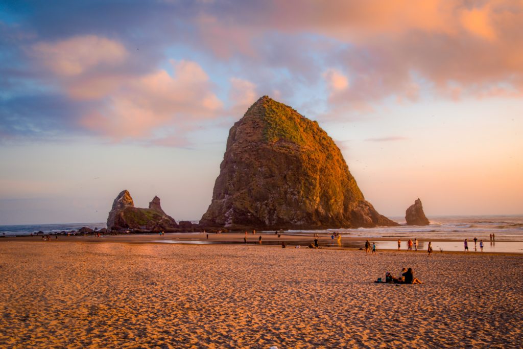 People gathering around Cannon Beach during the day
