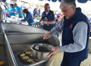 Festival-goers compete in a clam fritter cook-off