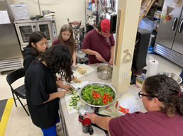 Kim Braveheart with LYD youth prepping food